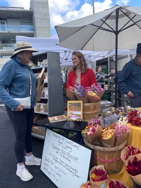 Hannah talking to a market customer