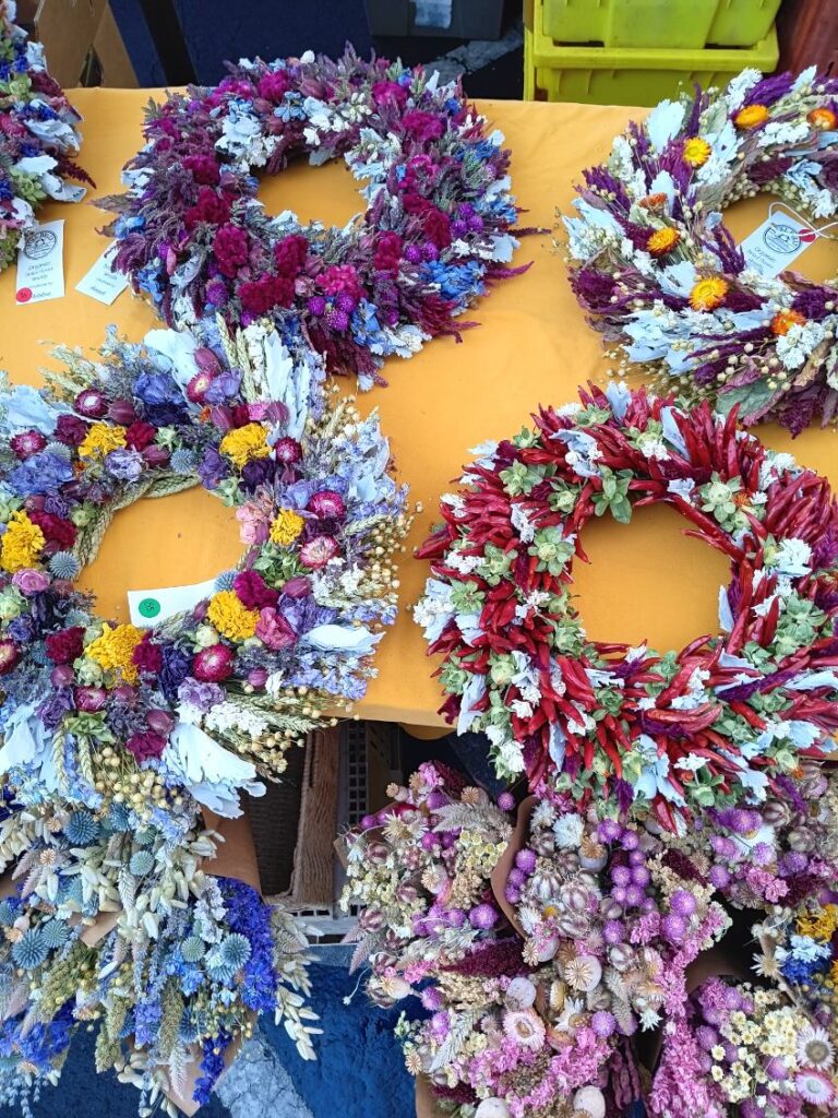 Dried flower wreaths on a yellow table cloth